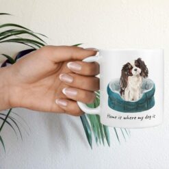 Home is where my dog is Tri colour King Charles Spaniel hand holding plant
