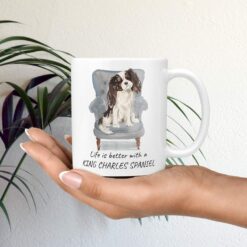 Life is better with Tri colour King Charles Spaniel Designs mug in hand plant