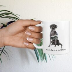 adventure is out there dog mug black lab hand holding plant