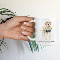 adventure is out there dog mug golden doodle hand holding plant