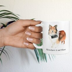 Adventure is out there Shetland Sheepdog dog mug (Illustrated collection) 17 adventure is out there dog mug shetland sheepdog hand holding plant